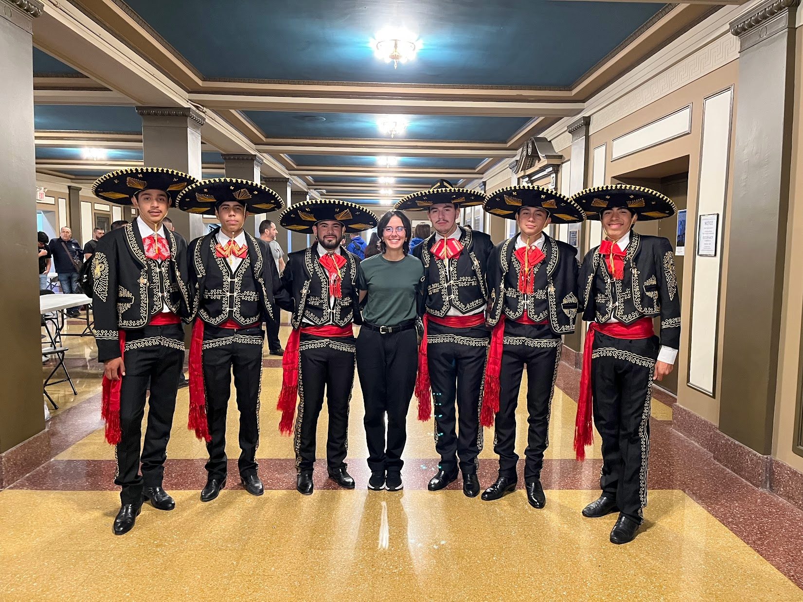 Six Durango students in charro suits with a YTC host