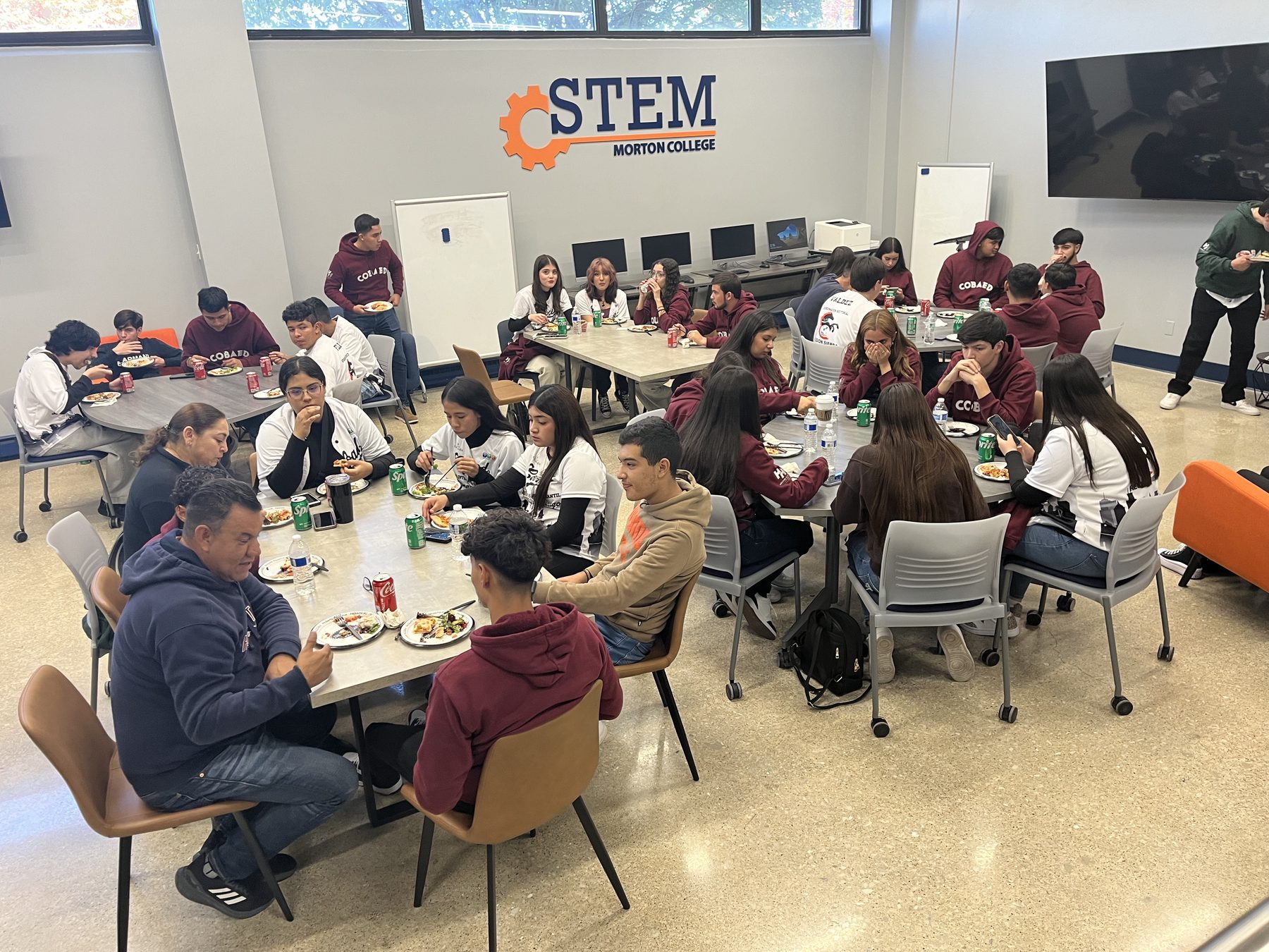 Students sharing a meal during a YTC exchange visit at Morton College